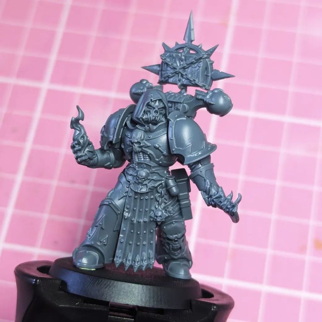 Kitbash conversion of an Emperors Children or Creations of Bile Chaos Legionary Space Marine with the hooded helm from the Nemesis Claw sprue and a Balefire Tome to make a Balefire Acolyte. Had had a flaming dagger and is summoning a fireball of psychic energy 