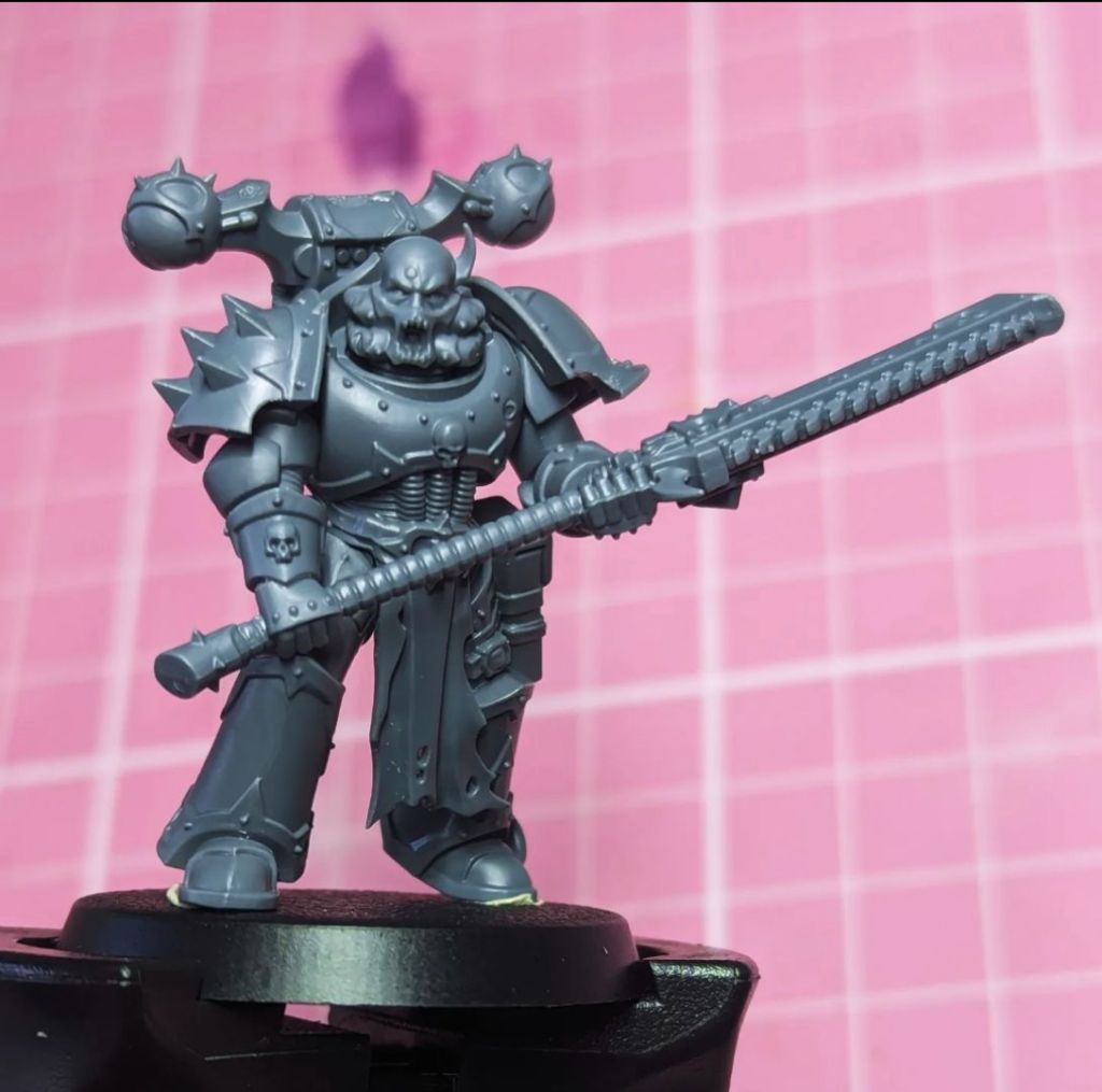 An Emperors Children or Creations of Bile Chaos Space Marine Legionary with a Nostraman Chainglaive as a Heavy Melee Weapon Kitbash with Chosen Chaos Marine Head