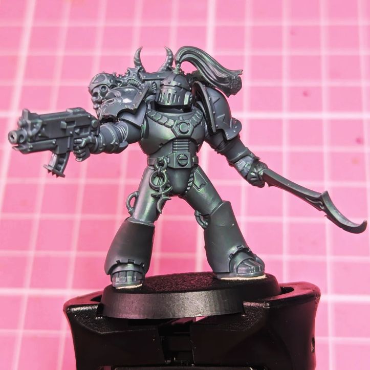 A kitbash of a Chaos Space Marine Chosen from the Emperor's Children Legion or the Creations of Bile